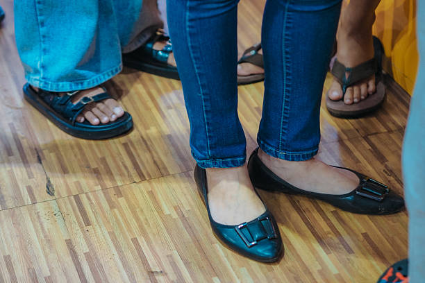 istock close up of feet in queue 2228598820