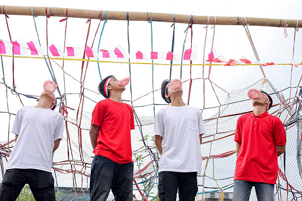 Indonesian Youth Compete In A Cracker Eating Contest, Celebrating Independence Day