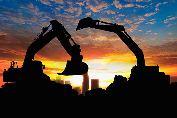 istock Crawler excavators silhouette are digging the soil . 2228599144