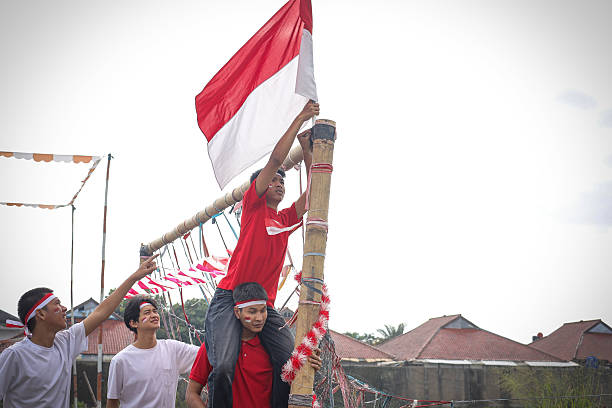 istock Young Men Waving The Indonesian Flag 2228599387
