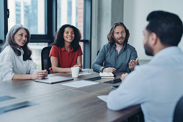 istock Mixed group of business persons on a meeting 2228601371