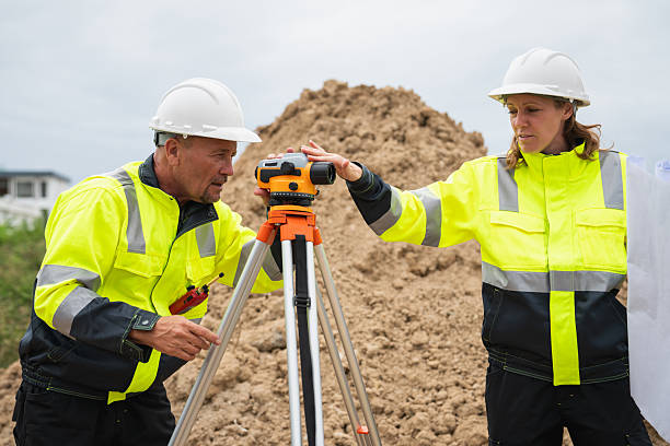 istock The survey team is using a theodolite and road construction plans. Civil engineers are measuring with surveying tools during the construction 2228601704