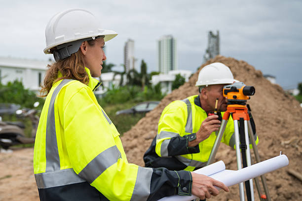 istock The survey team is using a theodolite and road construction plans. Civil engineers are measuring with surveying tools during the construction 2228601738