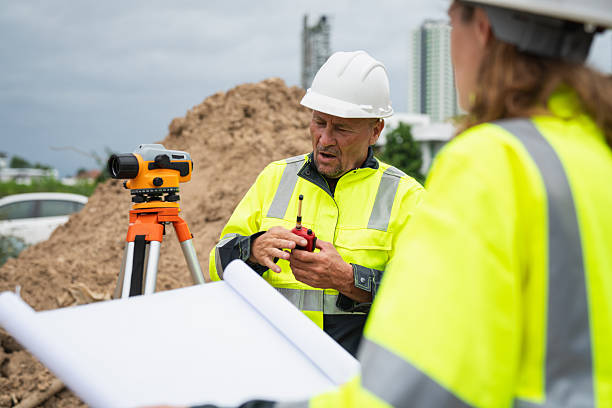 istock The survey team is using a theodolite and road construction plans. Civil engineers are measuring with surveying tools during the construction 2228601749
