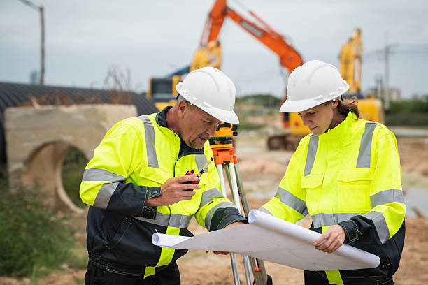 istock The survey team is using a theodolite and road construction plans. Civil engineers are measuring with surveying tools during the construction 2228601770