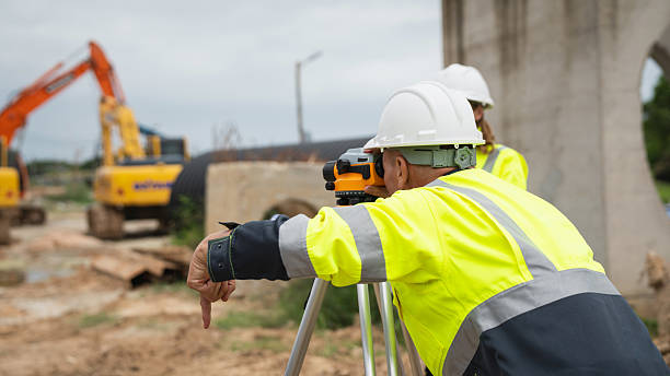 istock The survey team is using a theodolite and road construction plans. Civil engineers are measuring with surveying tools during the construction 2228601783