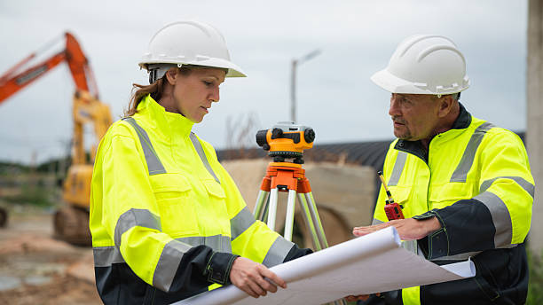 istock The survey team is using a theodolite and road construction plans. Civil engineers are measuring with surveying tools during the construction 2228601812