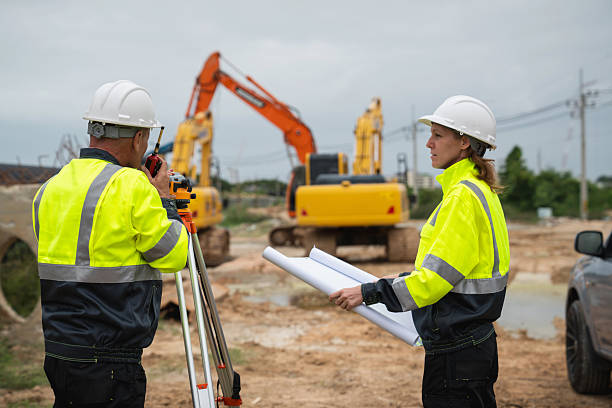 istock The survey team is using a theodolite and road construction plans. Civil engineers are measuring with surveying tools during the construction 2228601870