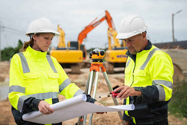 istock The survey team is using a theodolite and road construction plans. Civil engineers are measuring with surveying tools during the construction 2228601880