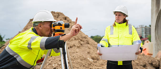 istock The survey team is using a theodolite and road construction plans. Civil engineers are measuring with surveying tools during the construction 2228601922