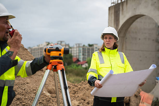 istock The survey team is using a theodolite and road construction plans. Civil engineers are measuring with surveying tools during the construction 2228601940