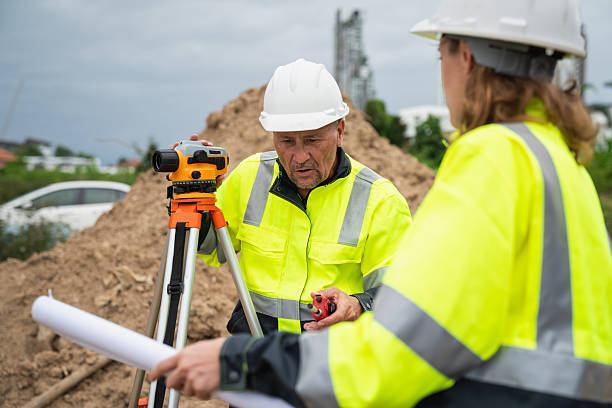 istock The survey team is using a theodolite and road construction plans. Civil engineers are measuring with surveying tools during the construction 2228602025
