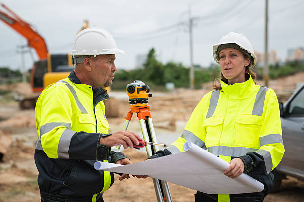 istock The survey team is using a theodolite and road construction plans. Civil engineers are measuring with surveying tools during the construction 2228602092