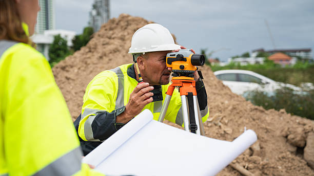 istock The survey team is using a theodolite and road construction plans. Civil engineers are measuring with surveying tools during the construction 2228602138