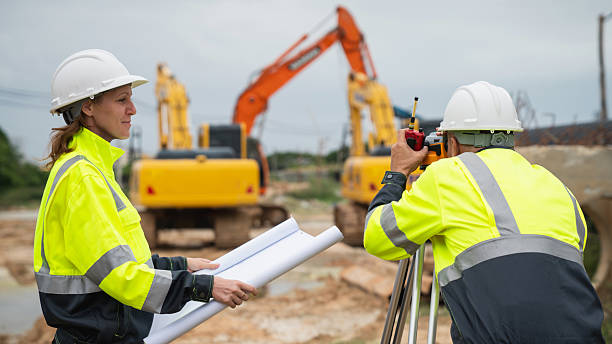 istock The survey team is using a theodolite and road construction plans. Civil engineers are measuring with surveying tools during the construction 2228602149