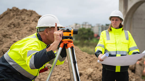 istock The survey team is using a theodolite and road construction plans. Civil engineers are measuring with surveying tools during the construction 2228602221