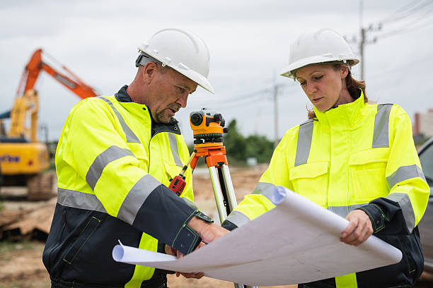 istock The survey team is using a theodolite and road construction plans. Civil engineers are measuring with surveying tools during the construction 2228602231