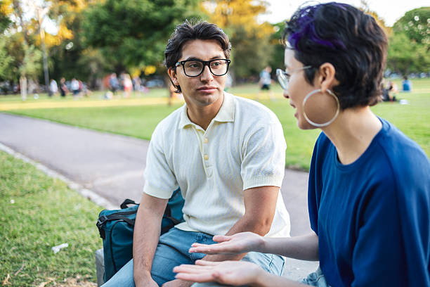 istock Young friends having supportive conversing  in a public park 2228602290