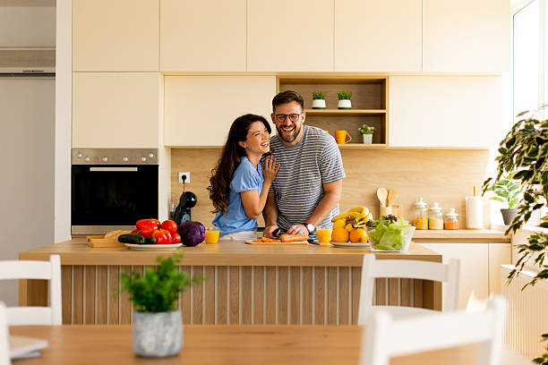 istock Joyful couple cooking together in a bright kitchen filled with fresh ingredients 2228605580