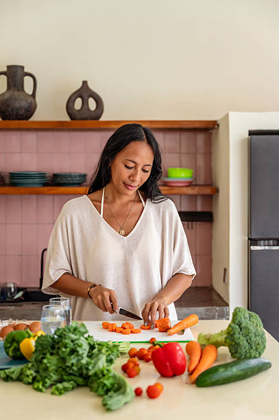 istock Healthy Cooking Preparation with Fresh Vegetables at a Cozy Home Kitchen 2228608034