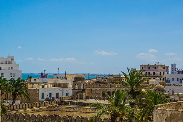 The ancient Medina of Sousse, located in Tunisia, is a stunning UNESCO heritage site that captures the historic charm of North Africa. This old city, with its narrow streets, stone houses, and vibrant souk, offers an authentic glimpse into traditional life. From a panoramic view, the rooftops, cityscape, and nearby sea view blend into a breathtaking scene. The Islamic and Arab influences are visible in the architecture, reflecting centuries of culture, history, and tradition. The fortress walls that surround the medina alleys add to its timeless character, making it a must-visit cultural site for tourism, travel, and architecture lovers seeking to explore a truly historic, scenic, and authentic Mediterranean destination.