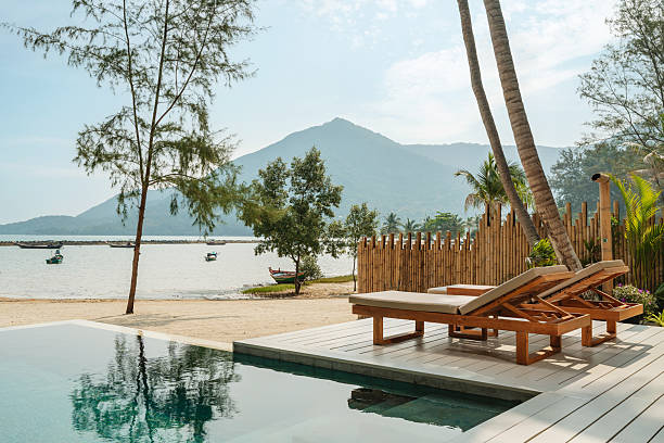 istock Relaxing deck chairs by the sea in tropical resort 2228611851