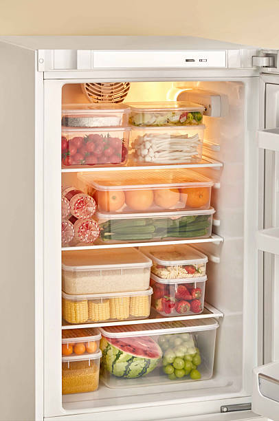 istock Organized Refrigerator with Fresh Produce in Clear Storage Containers, Open refrigerator with different food inside, closeup of refrigerator doors. 2228611971