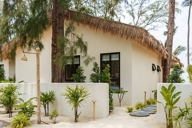 istock Tropical bungalow with thatched roof 2228613734