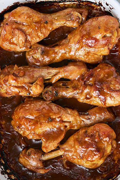 istock Chicken drumsticks baked in sauce in a baking dish close-up 2228614681