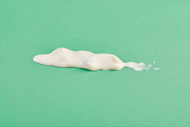 istock Cheese sauce, texture smeared on green background 2228614709