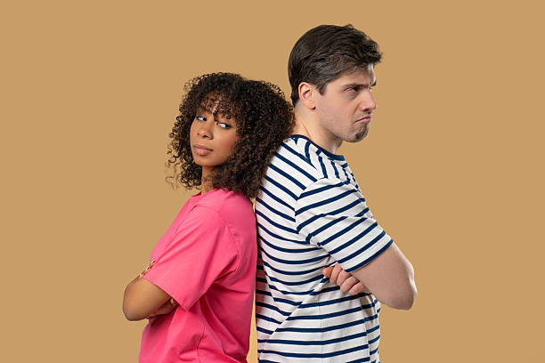 istock Young Offended Couple After Quarreling, Standing Back. Selfishness, Resentment 2228615815