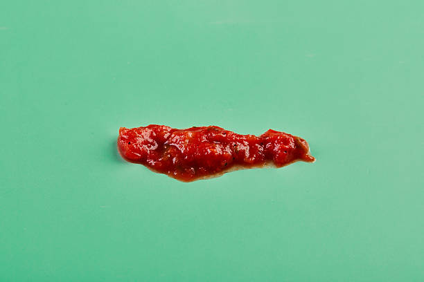 Spicy tomato salsa sauce, texture with drops on green background