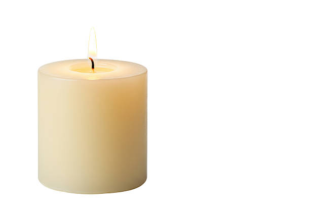 istock Isolated Burning Cream-Colored Pillar Candle 2228616333