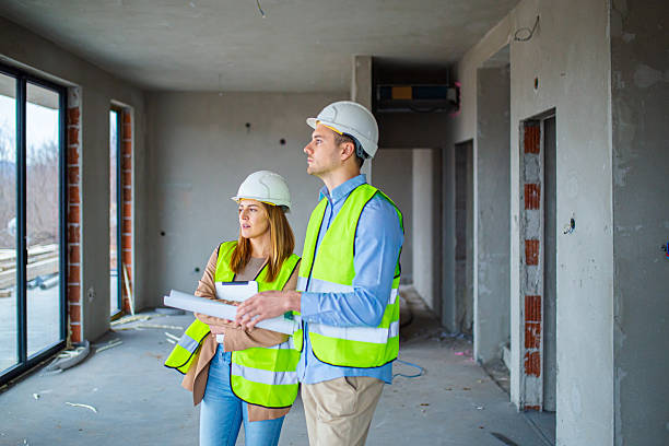 istock Team of Engineers Reviewing Construction Progress at Worksite 2228619163