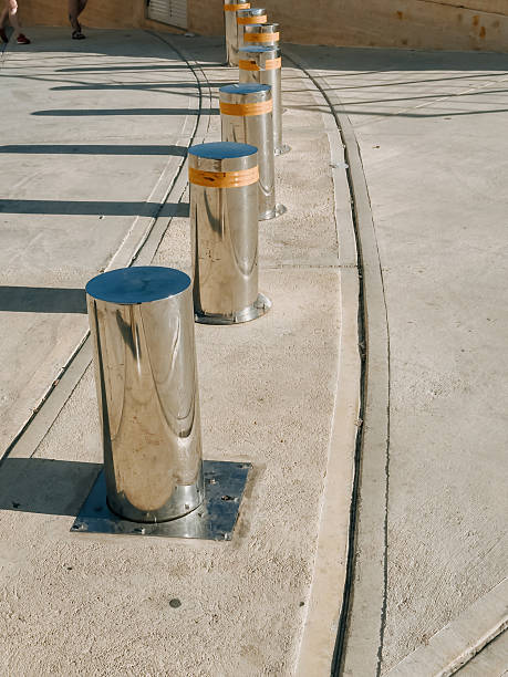istock Urban security bollards on a sunny day casting long shadows on modern pavement 2228619172