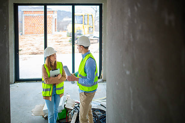 istock Team of Engineers Reviewing Construction Progress at Worksite 2228619219