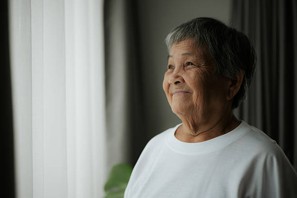 istock Elderly contemplation by the window. 2228620075