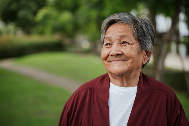 istock Elderly woman at park. 2228620215