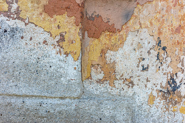Textured wall with peeling paint, showing an interesting interplay of colors and textures, creating a sense of age.