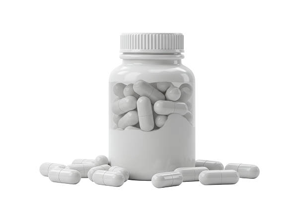 istock Isolated White Pills in and Around Plastic Bottle 2228622546