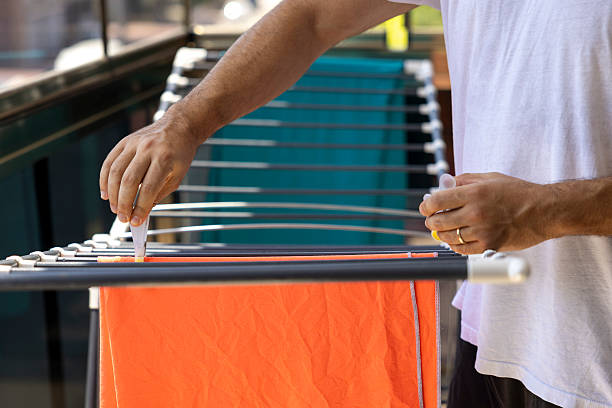 Man hanging washed clothes on a clothesline