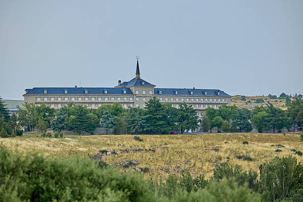 istock Panoramic view of a historic building with a central spire surrounded by trees 2228628345