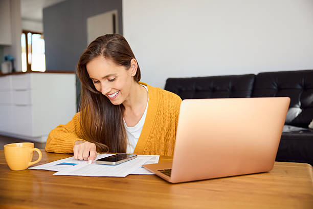 istock Smiling woman doing paperwork at home 2228629208