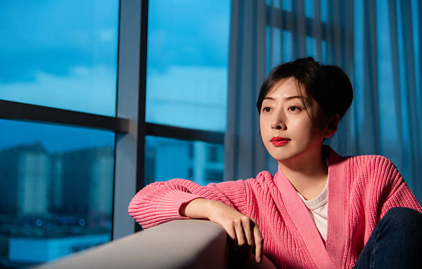 Woman leaning on the sofa and looking away
