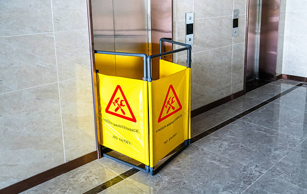 istock Under maintenance sign in front of the broken elevator 2228630183