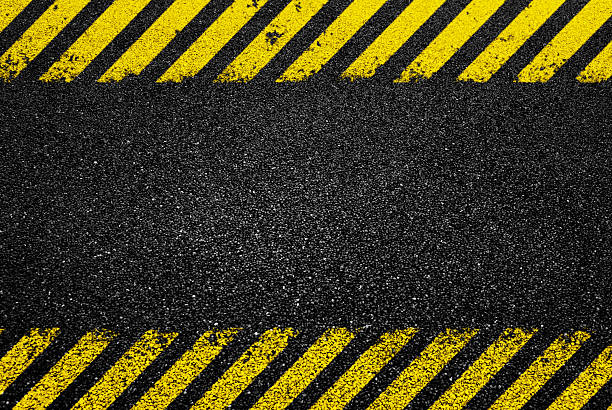Yellow diagonal stripes on asphalt road
