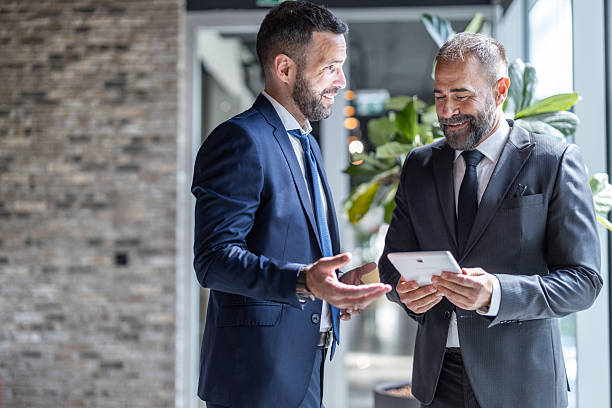 istock Business professionals reviewing digital tablet information 2228634035