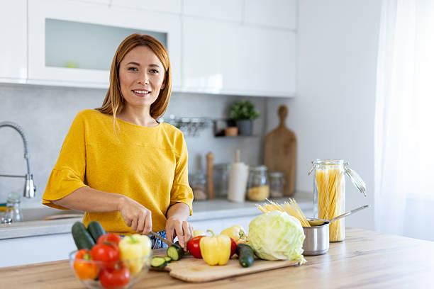 istock Bright Kitchen with Woman Enjoying Healthy Cooking 2228634060
