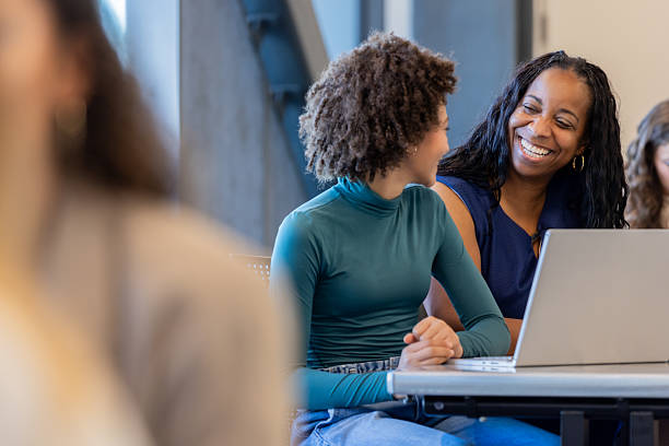 istock Mentor Helps Preteen Girl With Homework Assignment 2228634452