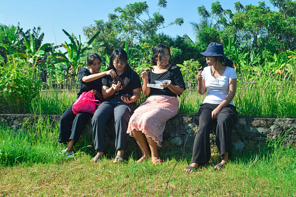 istock Girls talk and laugh during rural snack break 2228635102